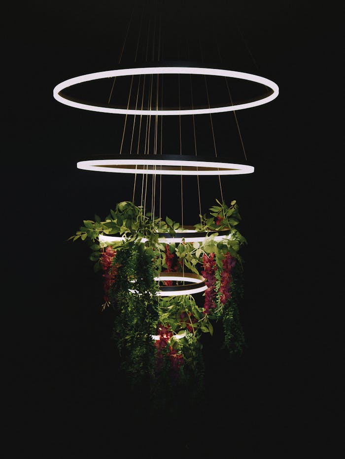 A stylish LED chandelier with cascading greenery and a sleek design, perfect for modern interiors.